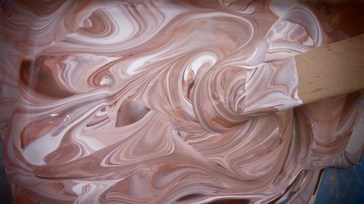 High-shear dissolver blade dispersing pigments into liquid paint formulation in mixing vessel