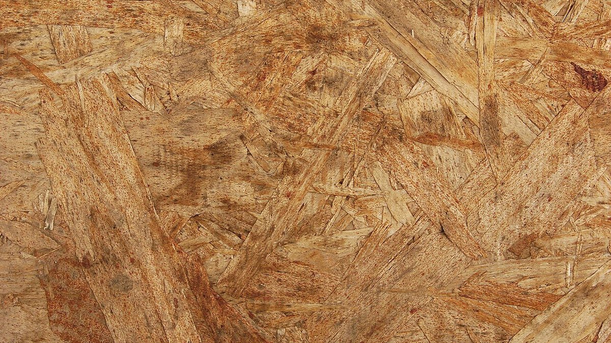 Heavy-duty hydraulic hot platen press curing resin-bonded wood panel boards in a timber processing plant